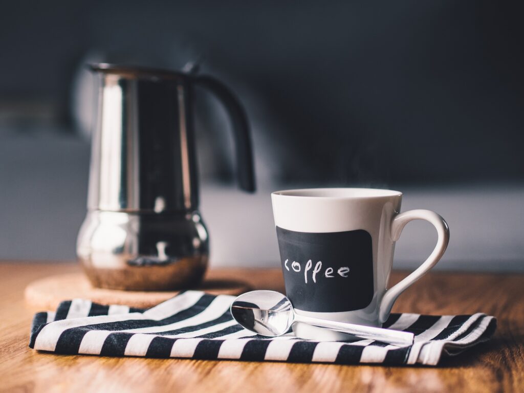 Coffee pot and coffee cup on table