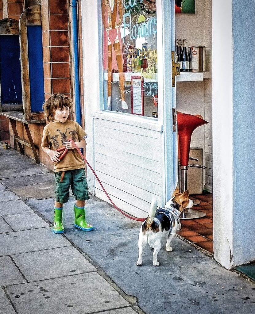 Little boy and dog outside of a shop